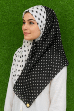 Woman wearing black and white polka dot cotton print hijab scarf, 36x73 inches, stylish shawl for girls and women.