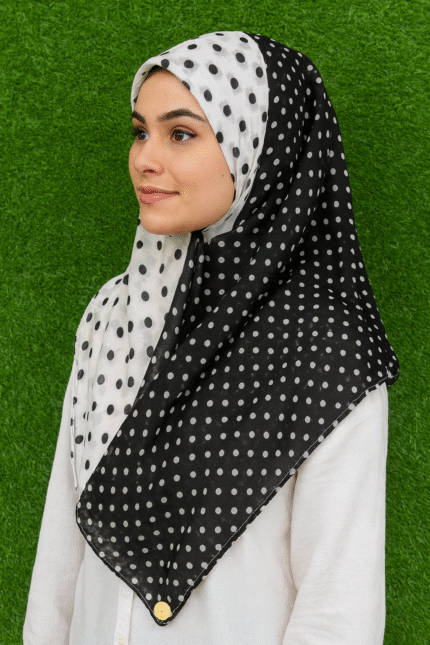 Woman wearing black and white polka dot cotton print hijab scarf, 36x73 inches, stylish shawl for girls and women.